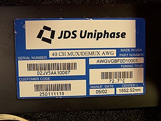 Product label shows 1x40 40-ch AWG Mux-DeMUX, JDS P/N: AWGVGBF0D10001, Center wavelength: 1552.52nm. Not completed product. 'Sell As Is', 'No return'